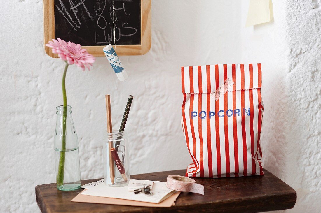 Homemade popcorn in a striped paper bag as a gift