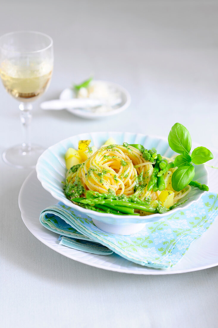 Spaghetti al pesto with green asparagus on plate