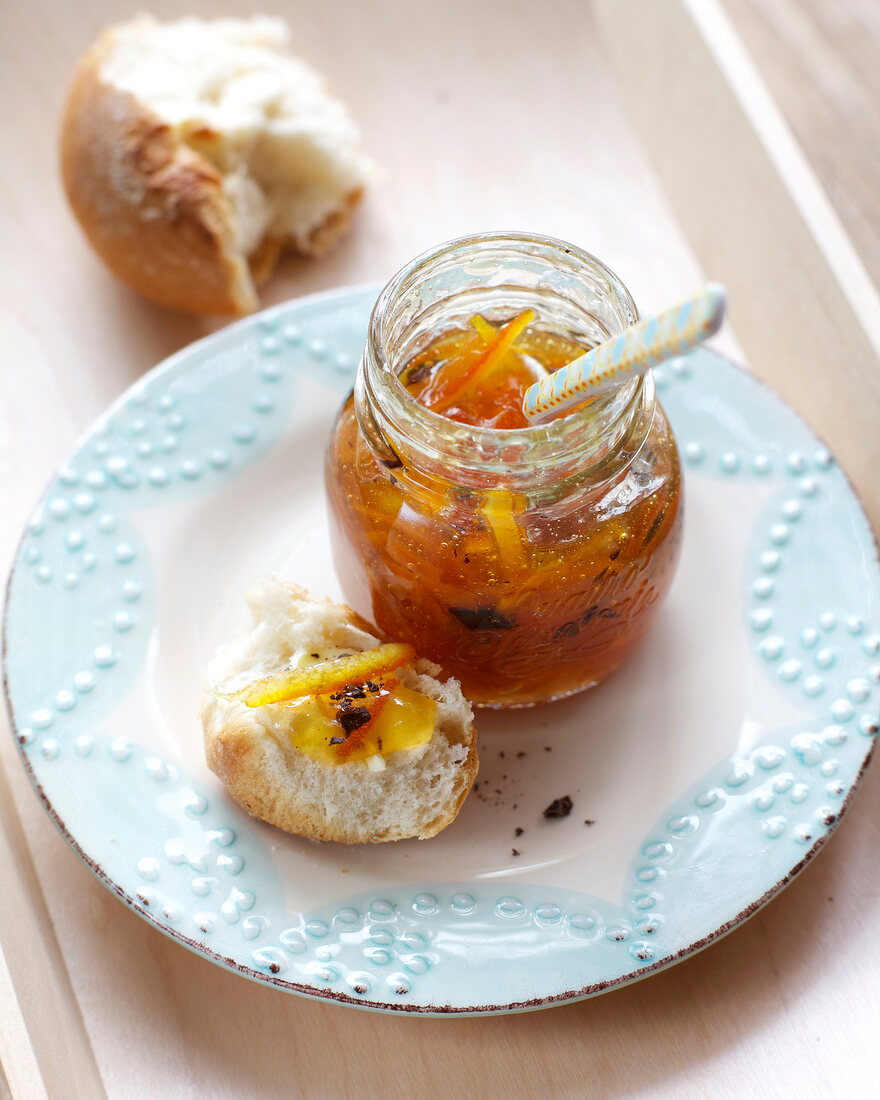 Homemade marmalade with ginger in jar on plate