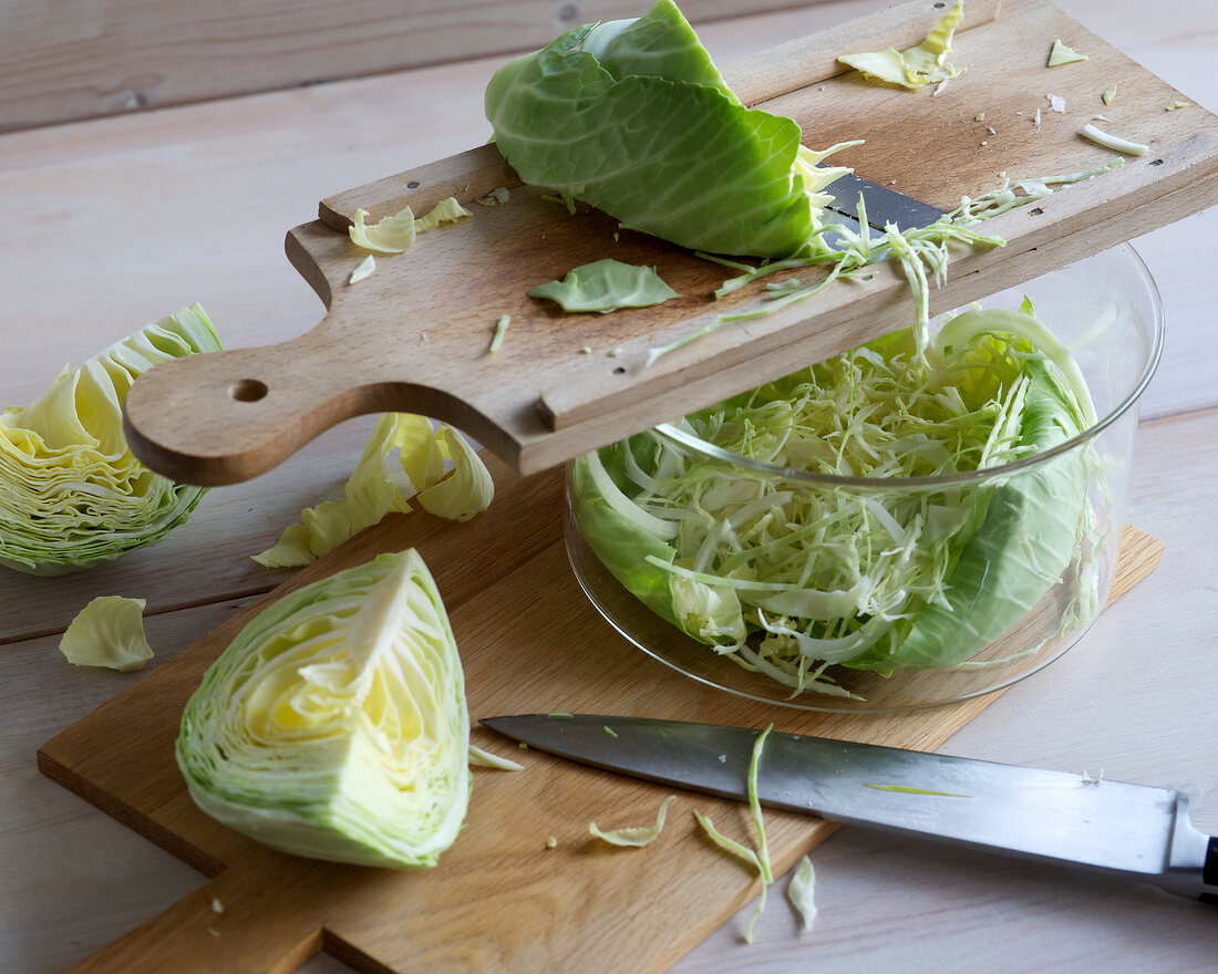 Cabbage being chopped in thin strips