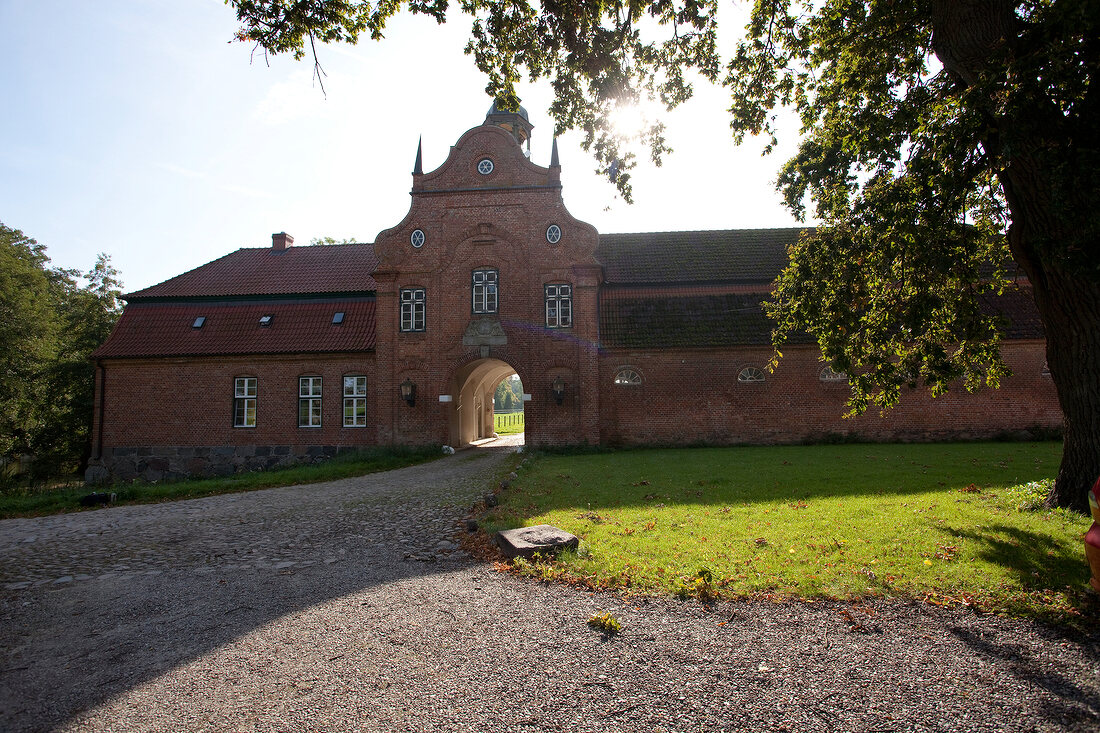 Facade of Kletkamp gatehouse with garden in front in Schleswig-Holstein, Germany