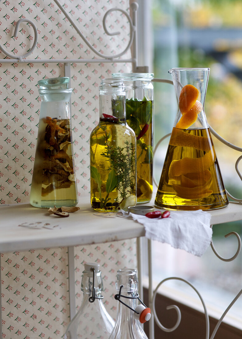 Four different flavoured oils in bottle on shelf