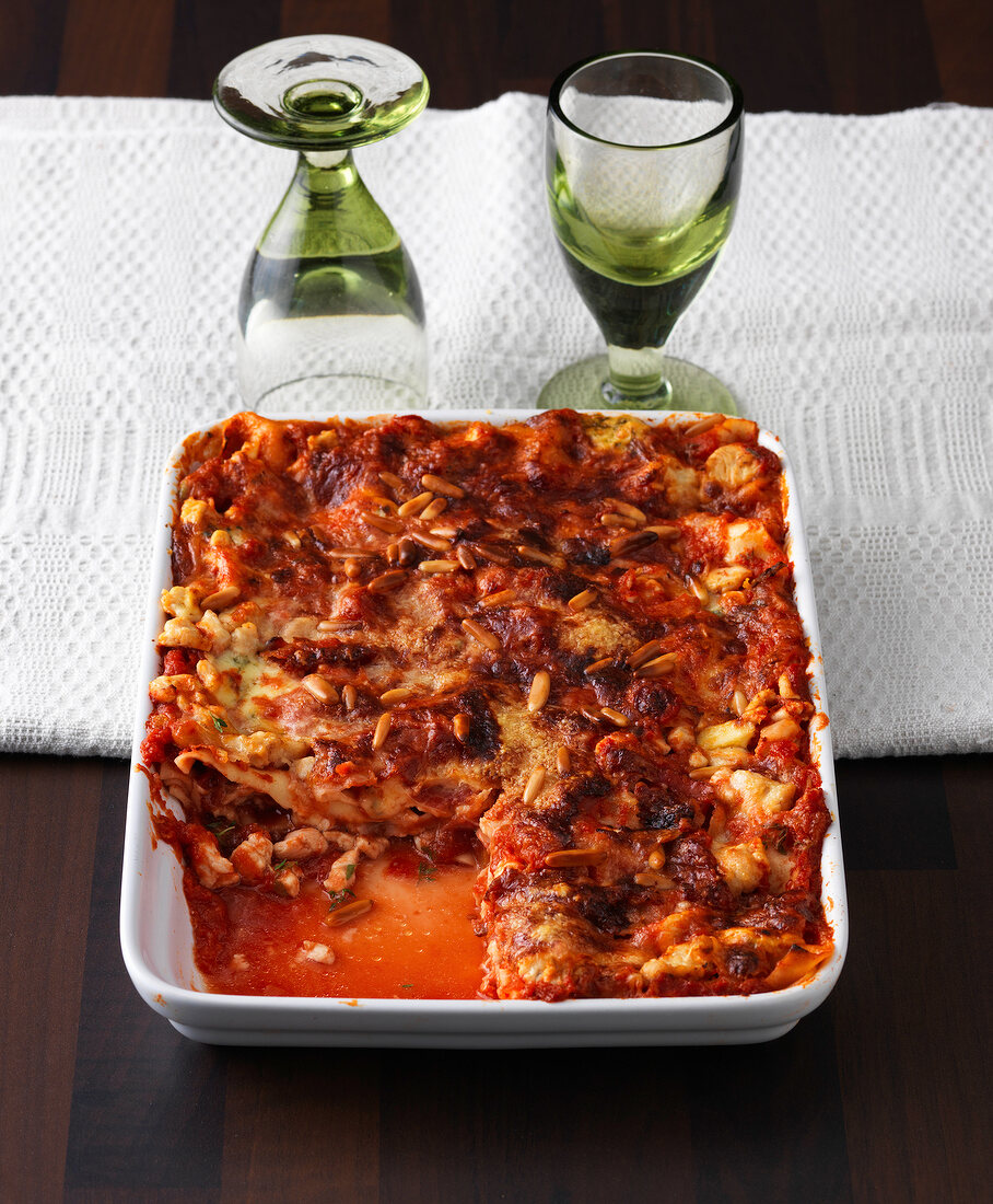 Chicken lasagne with tomatoes in baking dish