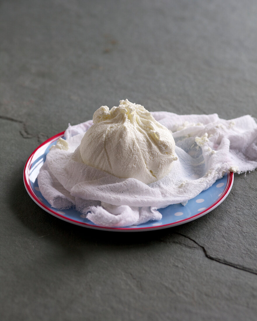 Homemade cream cheese in cheesecloth