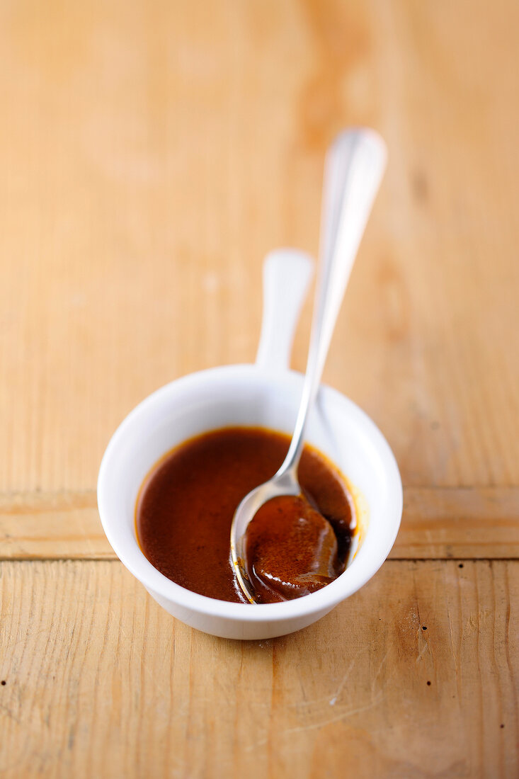 Brown sauce with spoon in bowl