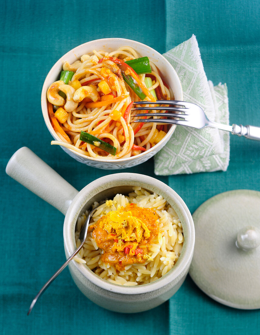 Two Asian style noodles in bowls 