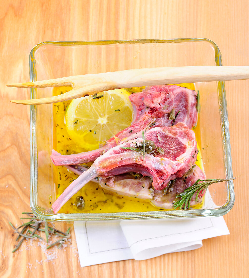 Rack of lamb with marinade in glass bowl