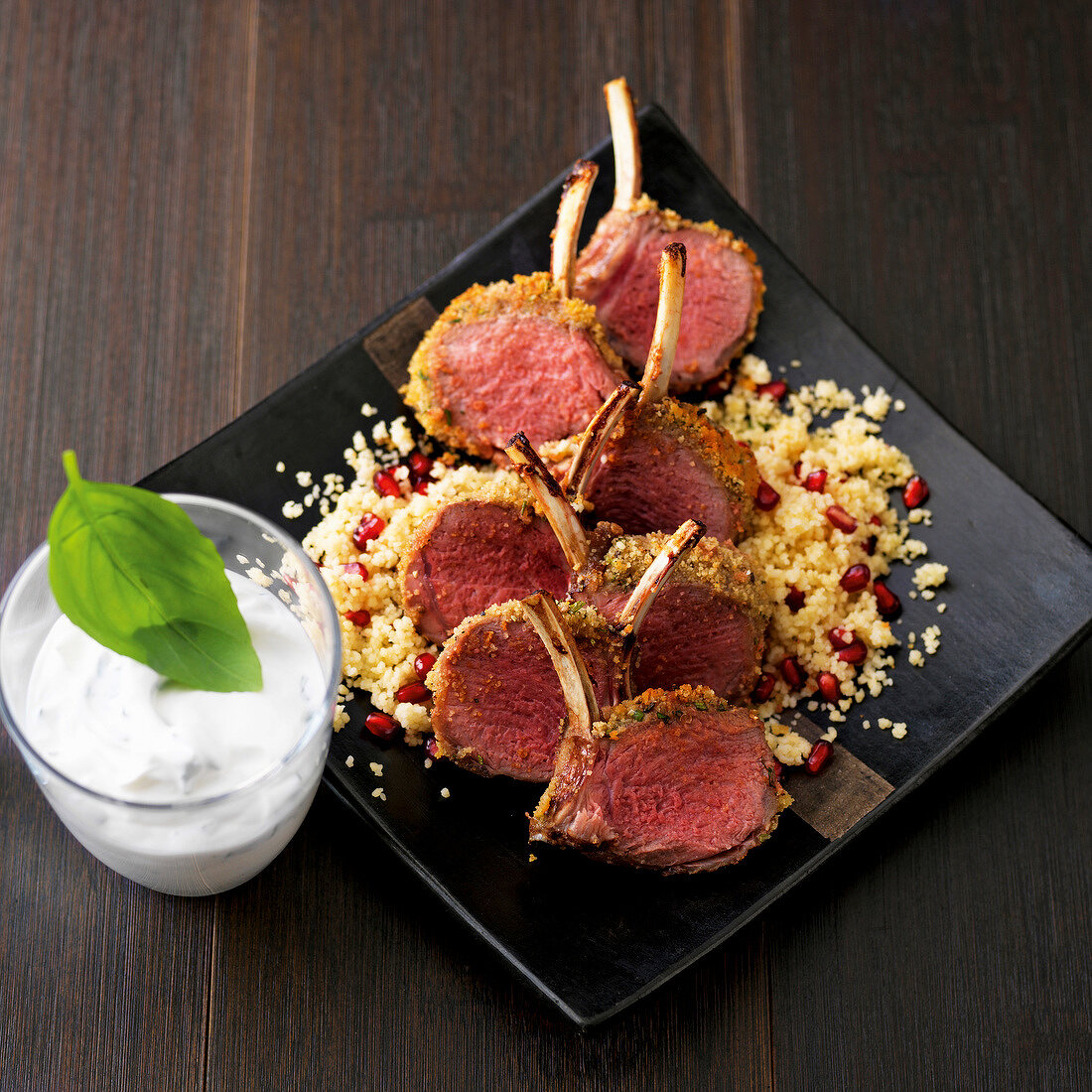 Rack of lamb with pomegranate couscous on plate