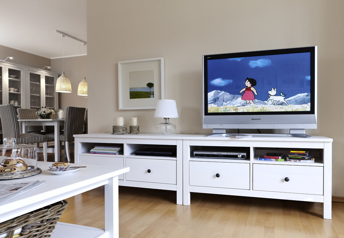 Flat screen TV on white furniture in living room