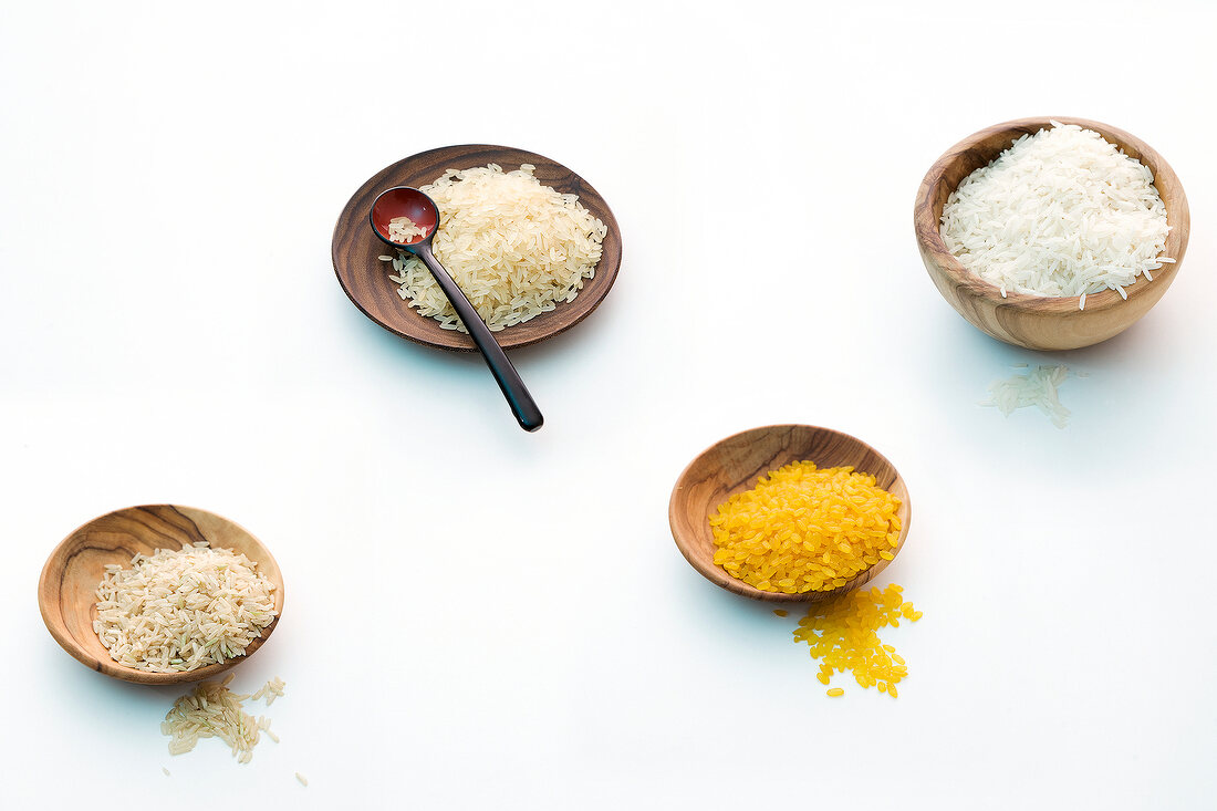 Long grain brown rice, basmati rice and risotto rice on white background