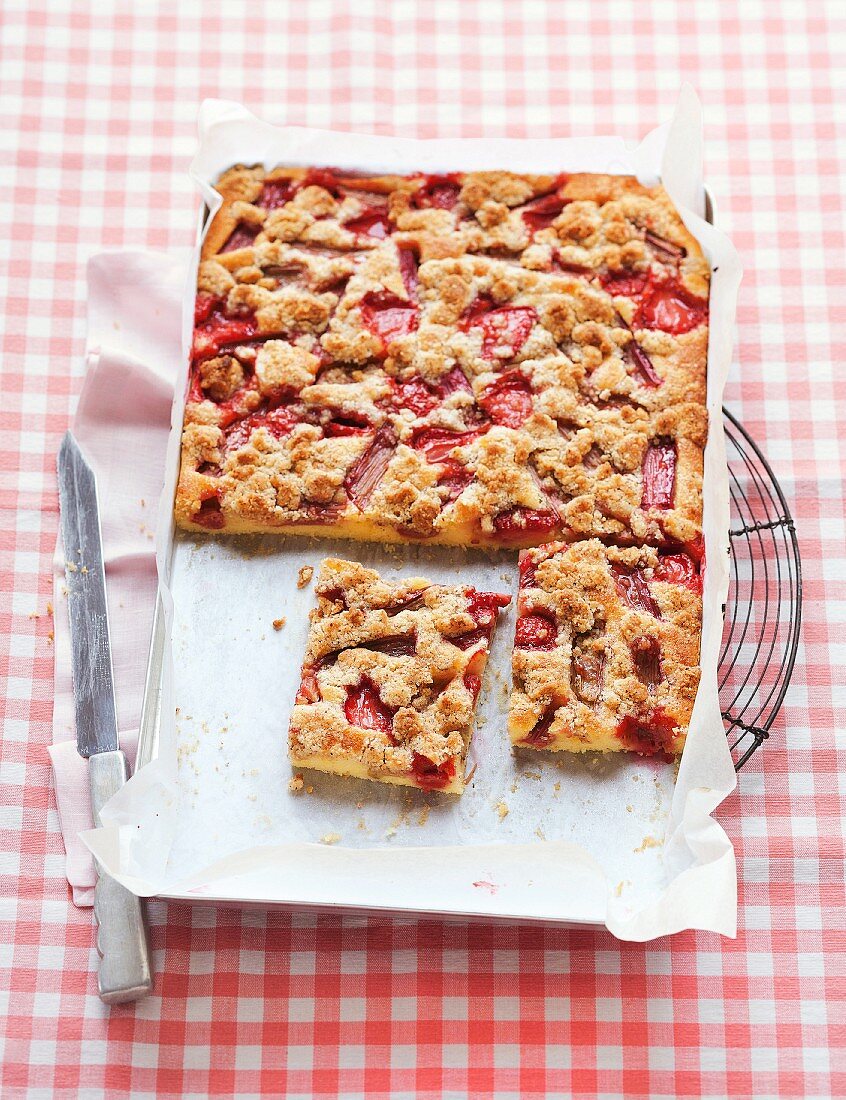 Tray bake crumble cake with strawberries and rhubarb
