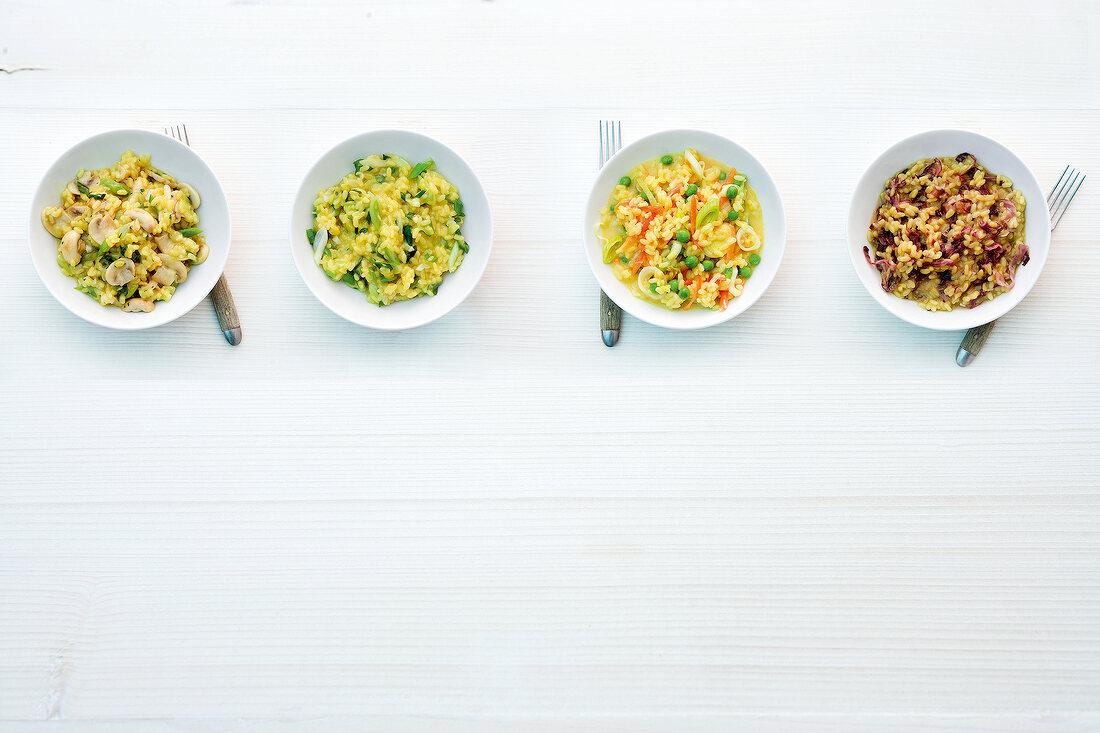 Four different type of risottos in bowls