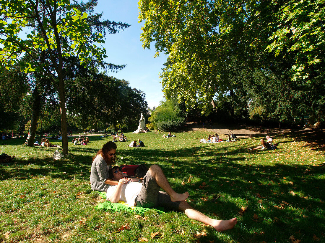 Couples relaxing in Parc Monceau in Paris, France