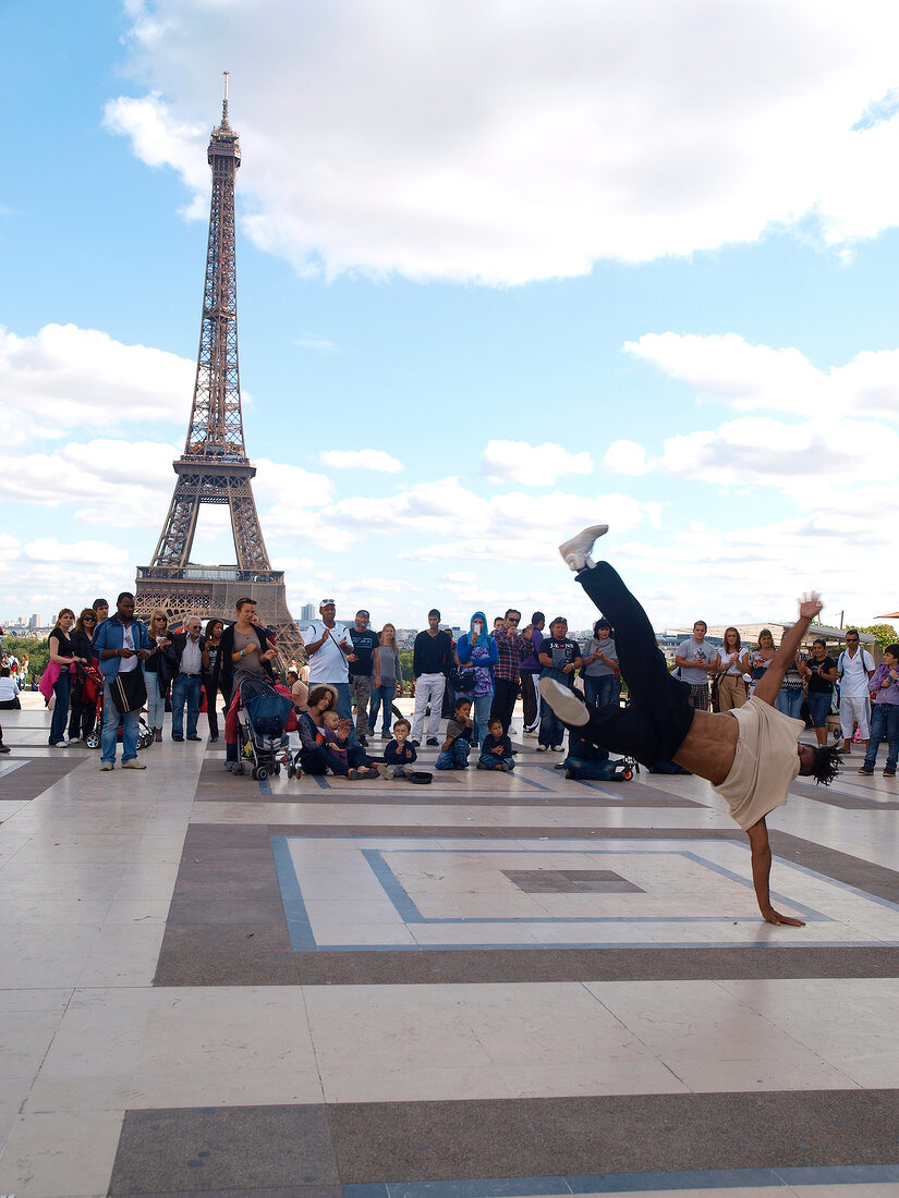 Street artists performing hip hop in front of Eiffel Tower, Paris, France