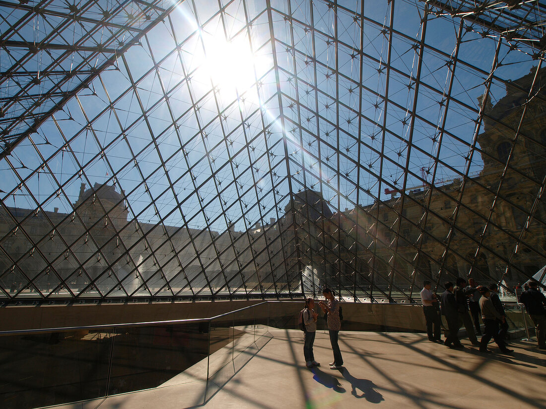 Tourists in Louvre Pyramid, Paris, France