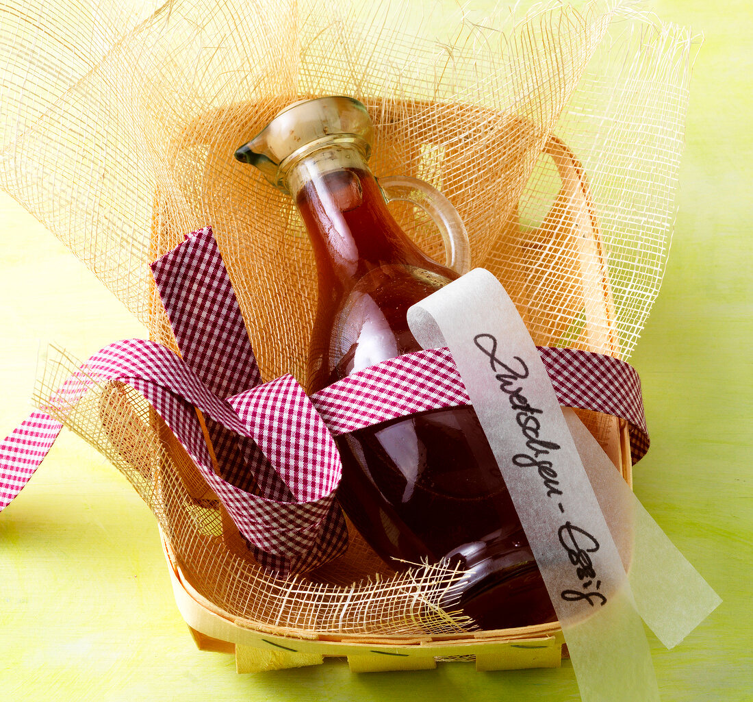 Close-up of plum vinegar in glass bottle in basket