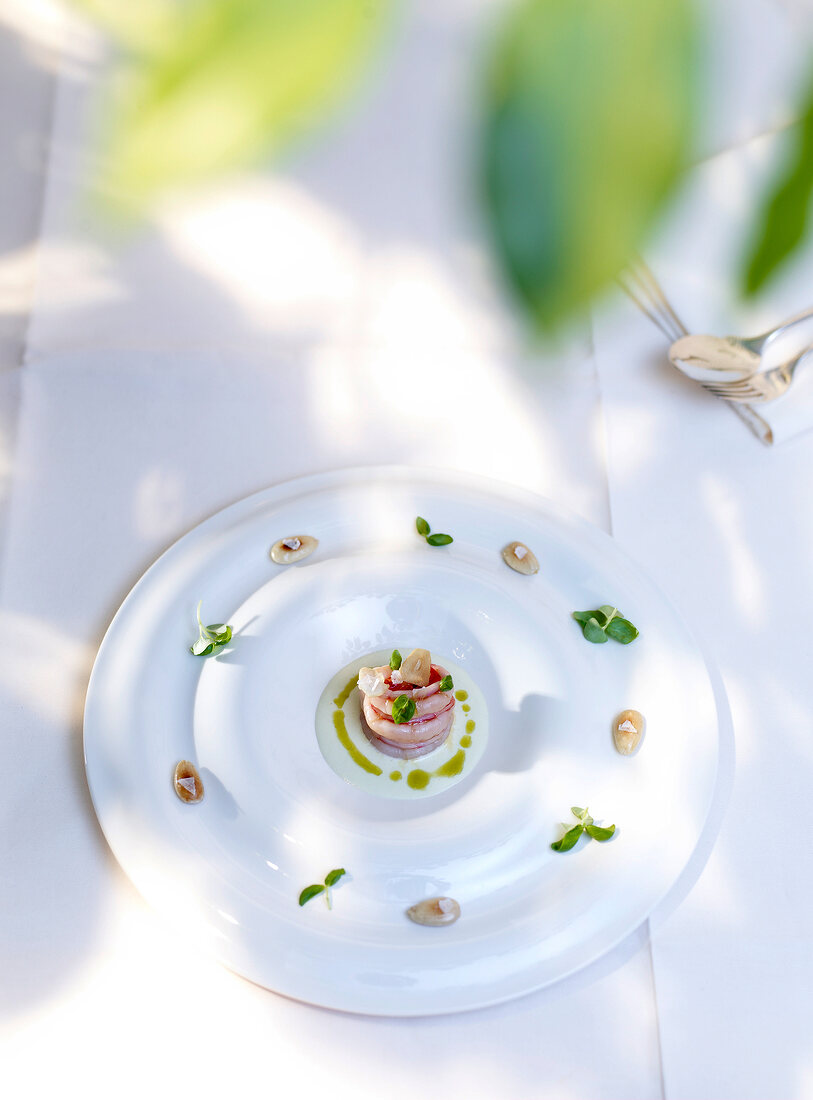 Gazpacho with almonds and prawns on plate