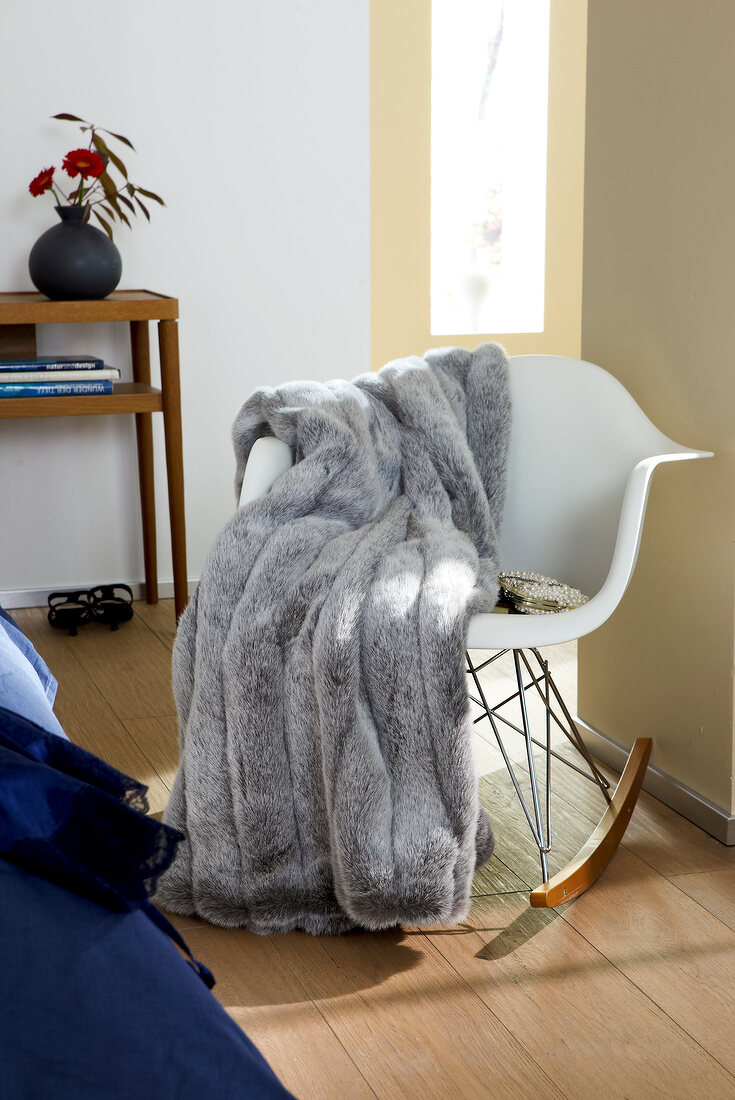 Blanket on white rocking chair