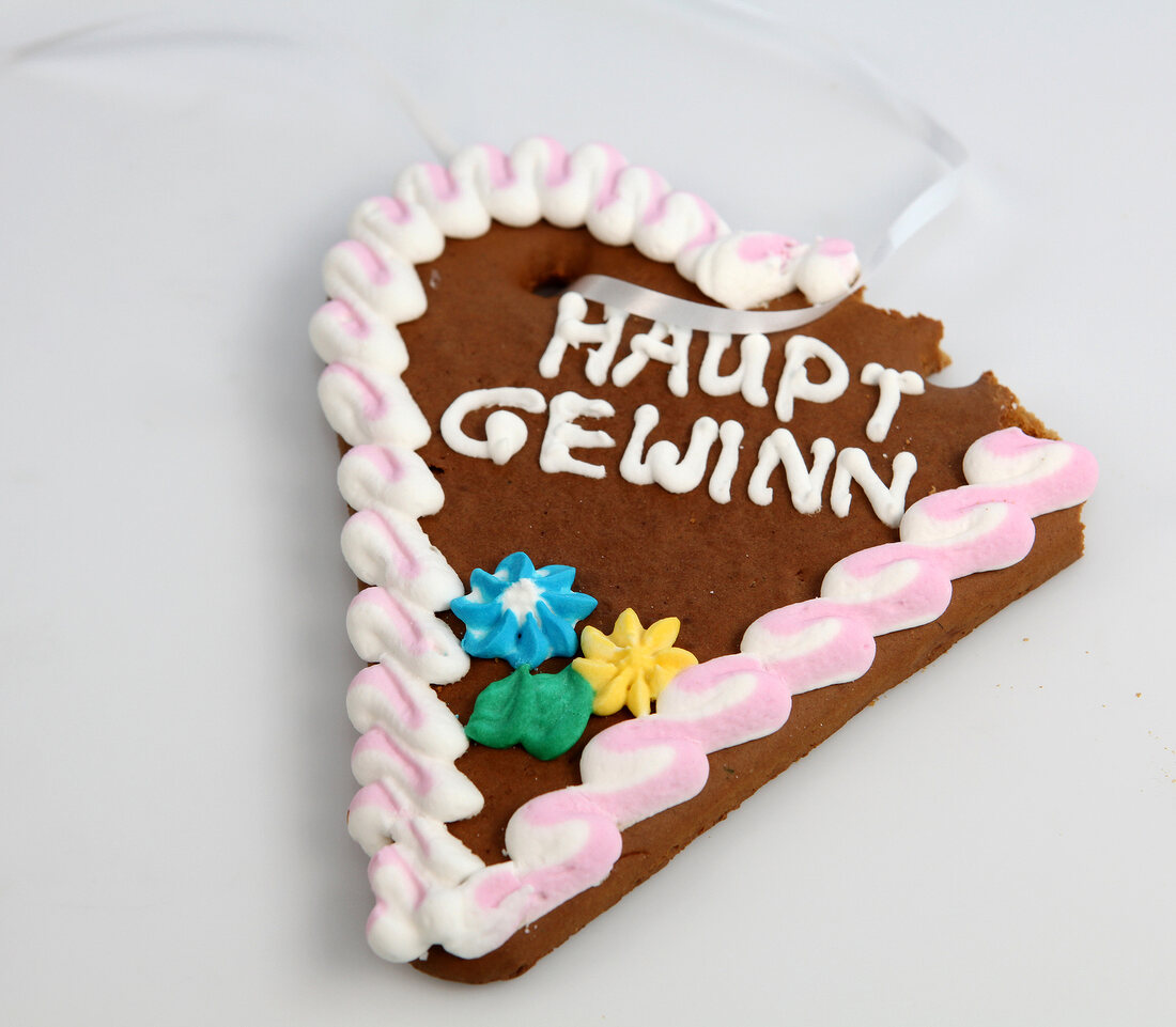 Heart shaped lebkuchen cake with icing on top on white background