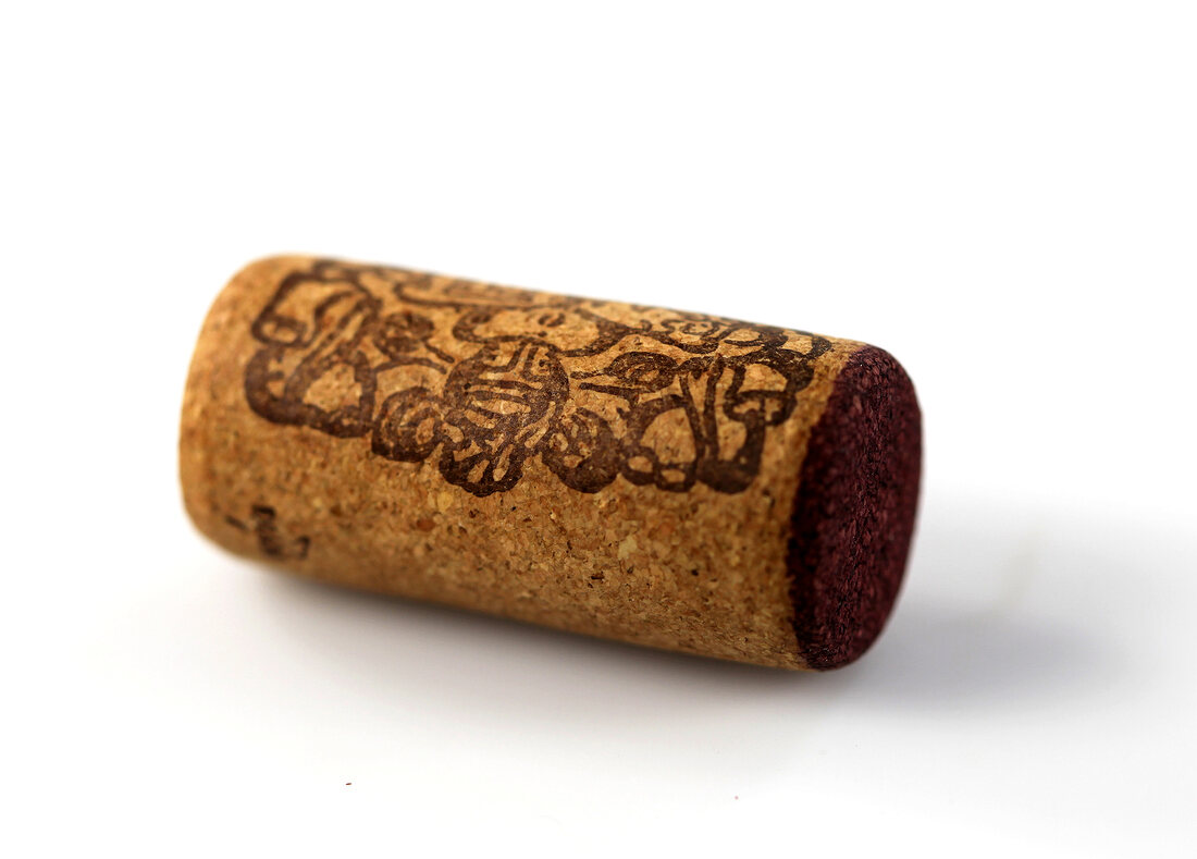 Cork of red wine bottle on white background