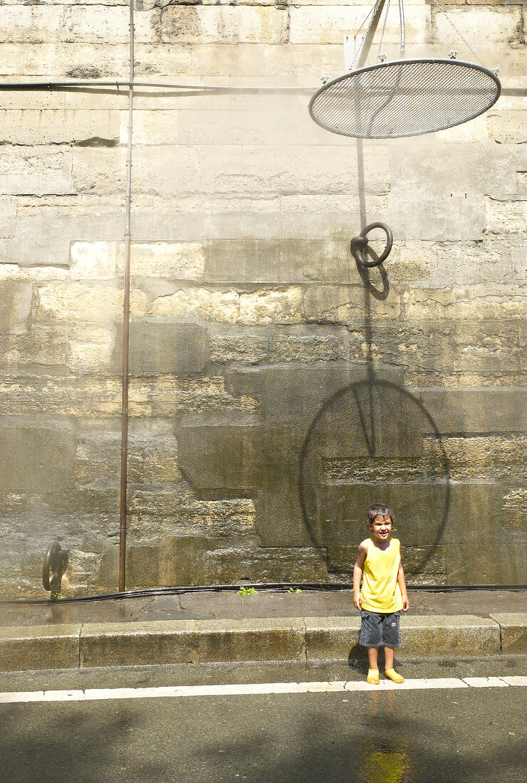 Children playing in water, Paris, France