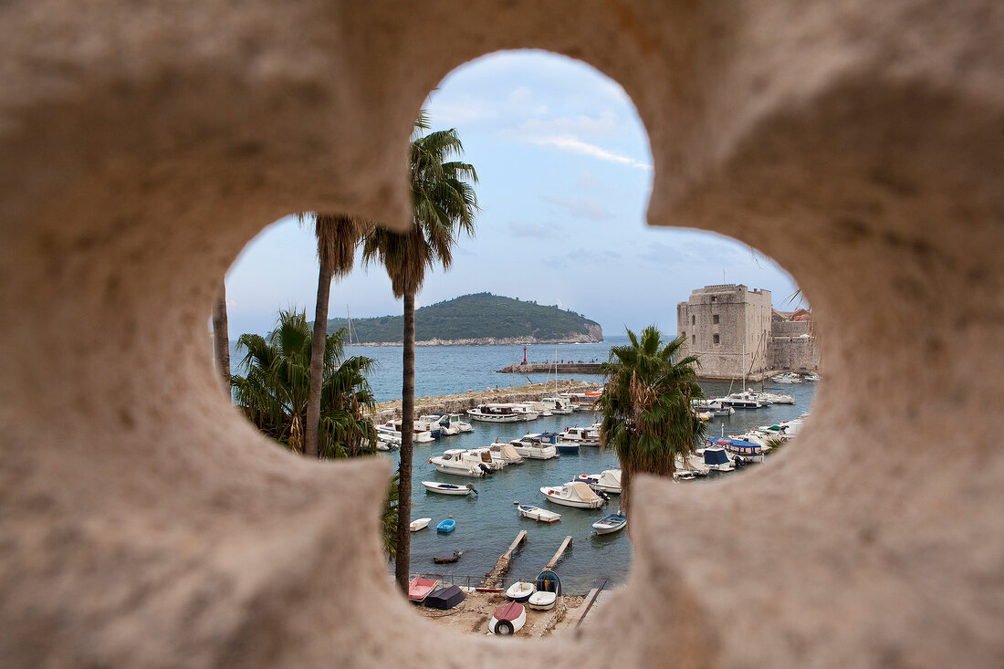 View of harbour and island through window embrasure of city wall in Dubrovnik, Croatia