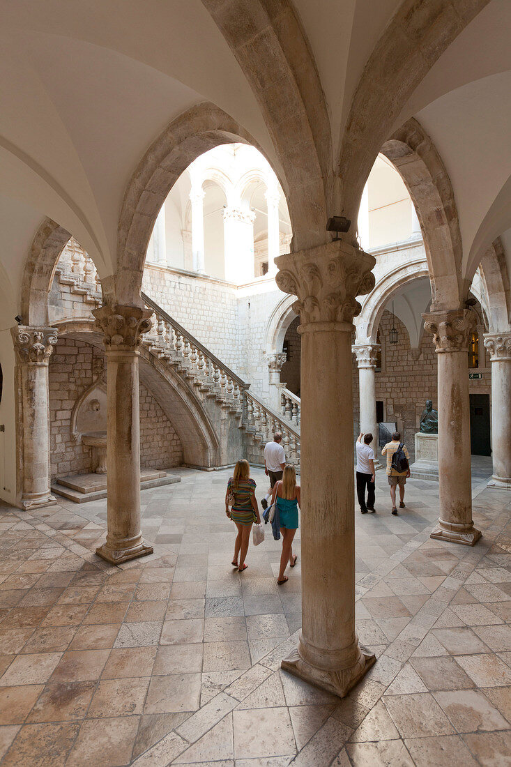 Tourists walking in portico of Rector's Palace, Dubrovnik, Croatia