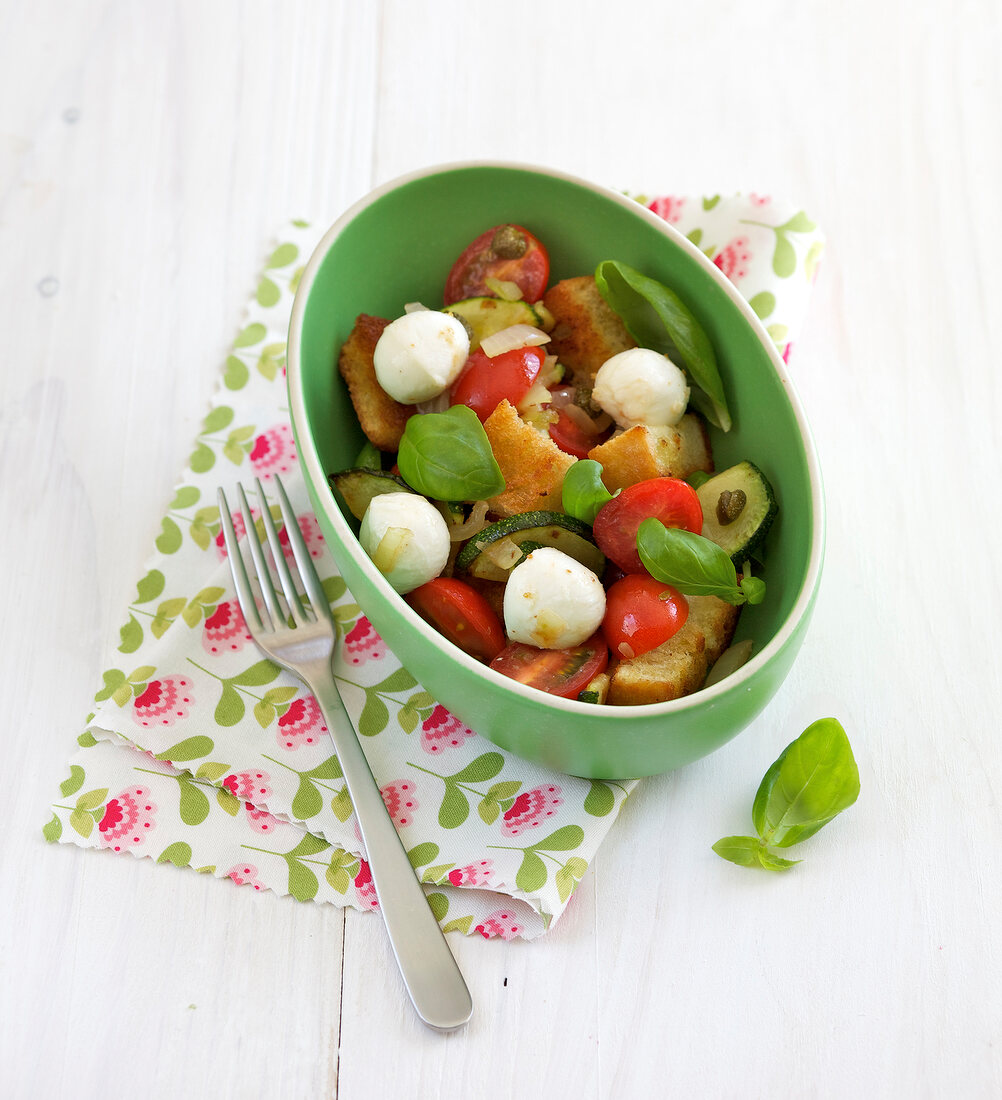 Ciabatta salad with mozzarella in bowl on napkin