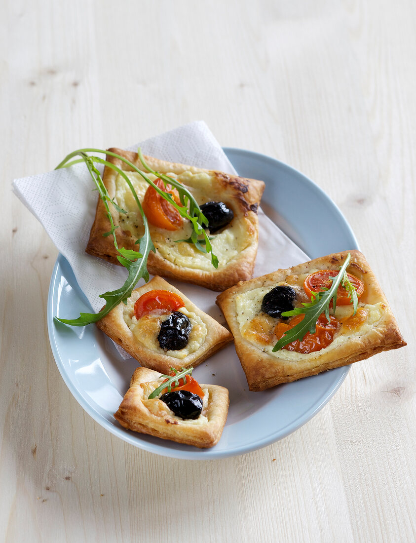 Puff pastry pizzas on plate