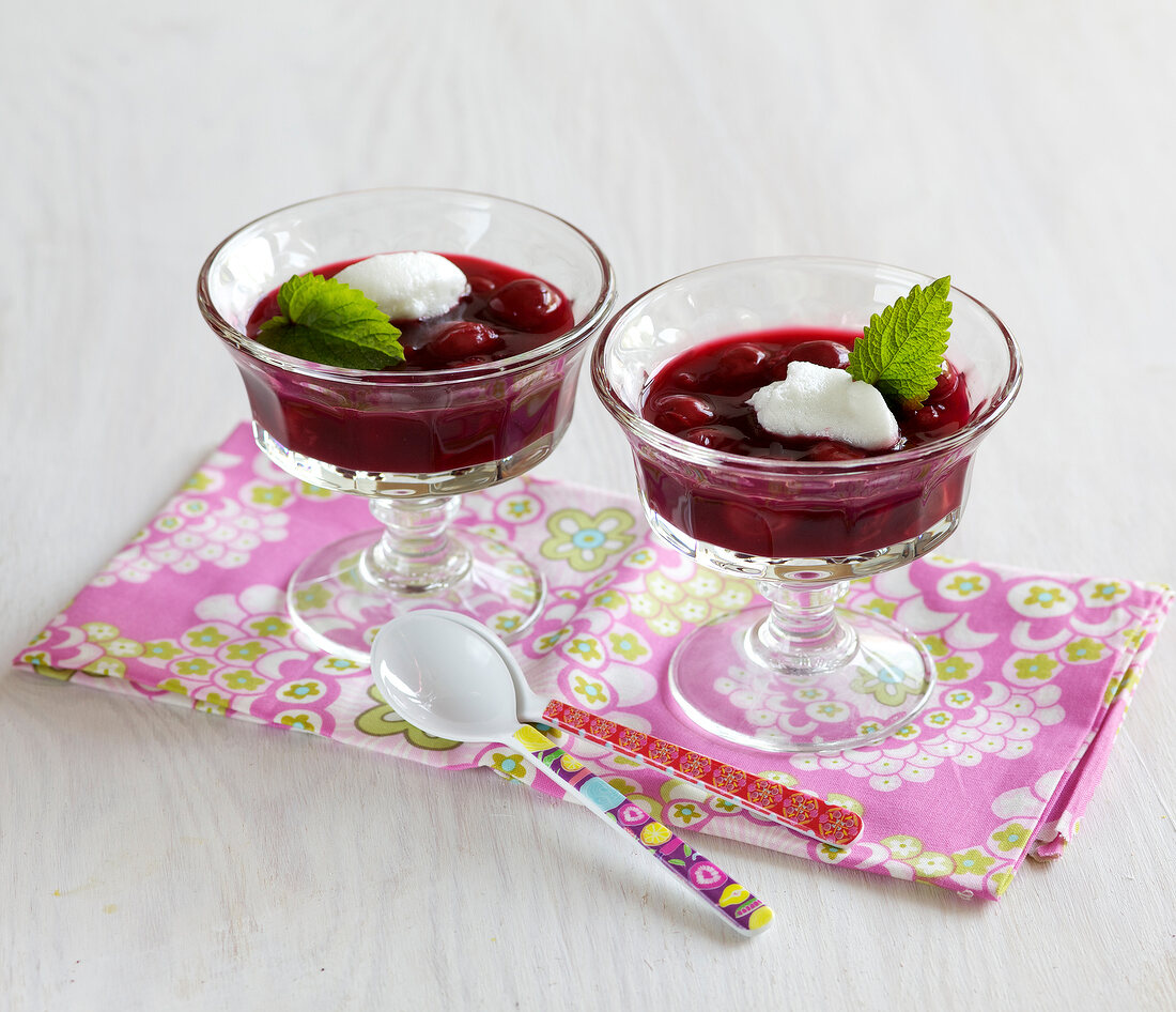 Cherry gazpacho with snow-eggs in glass bowls