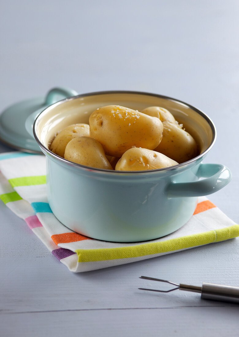 Jacket potatoes in pan on napkin