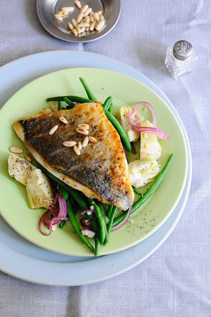 Sea bream fillet with artichokes, green beans and pine nuts