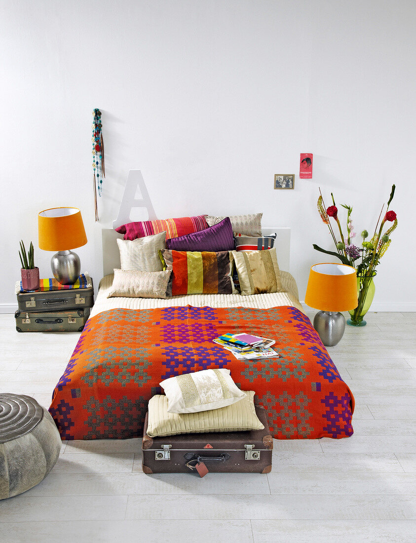 Bedroom with colourful cushions, bed sheets and bed