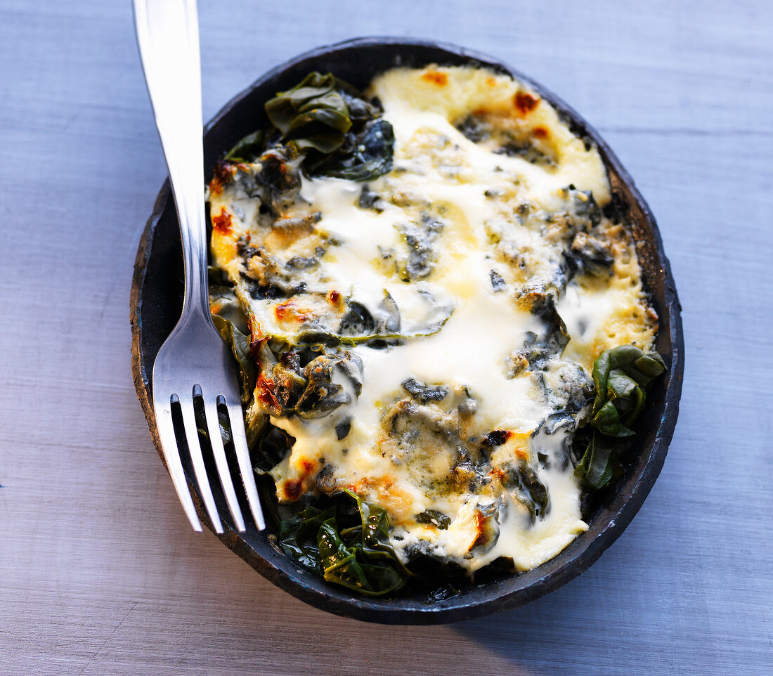Baked spinach with cream on plate