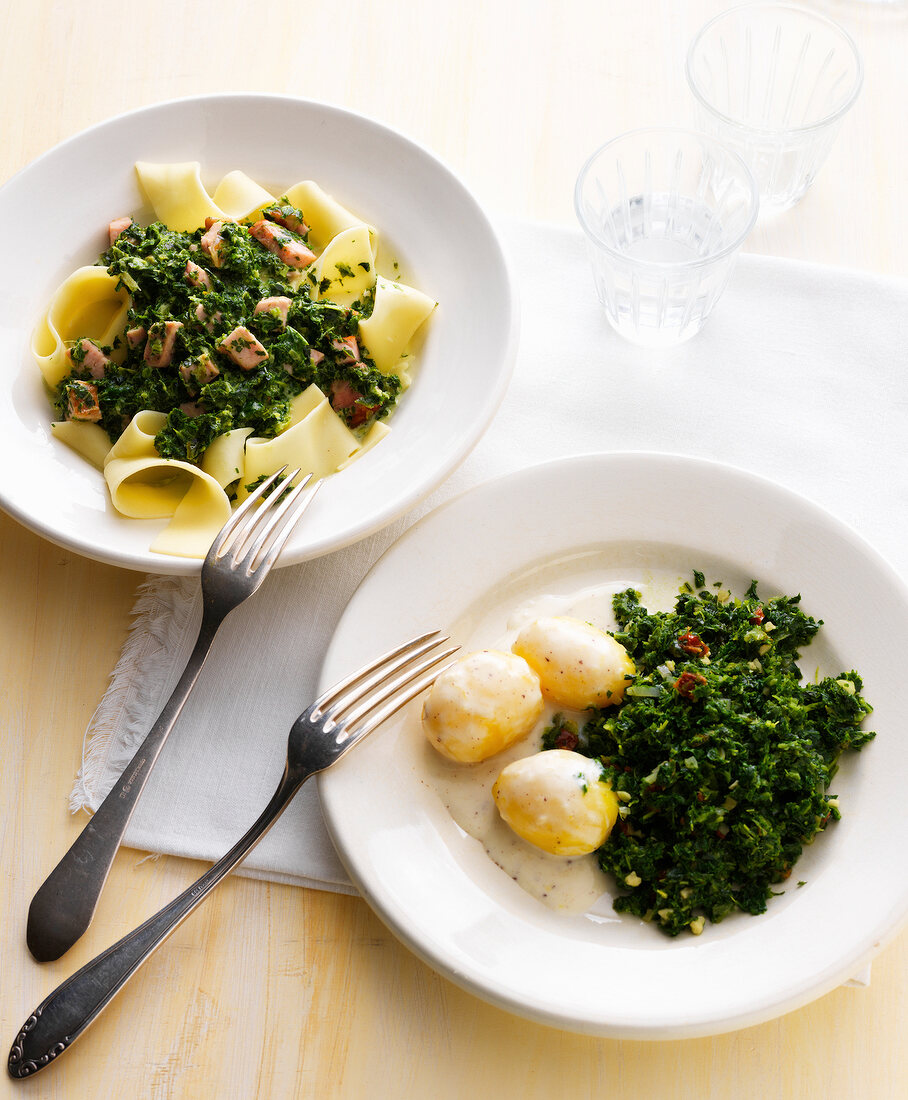 Kale with pasta and potatoes on plates