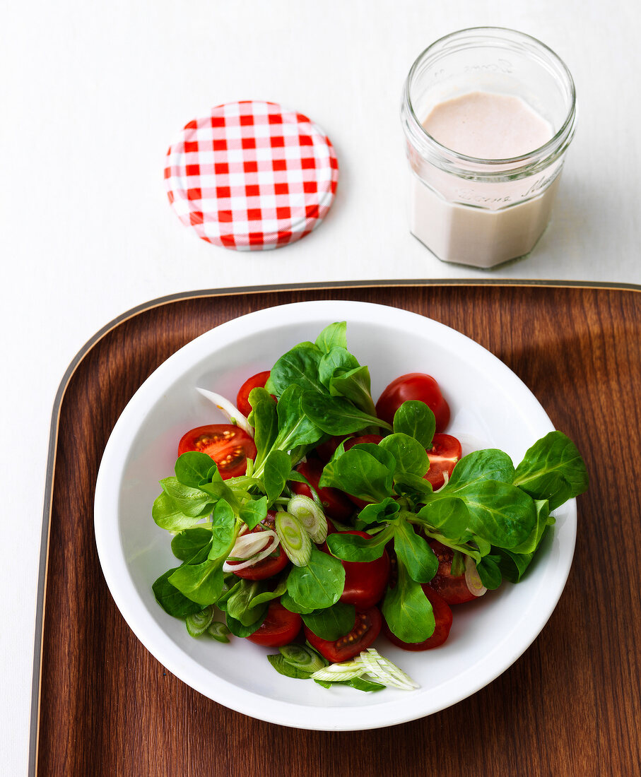 Lettuce and tomato salad with tuna in bowl