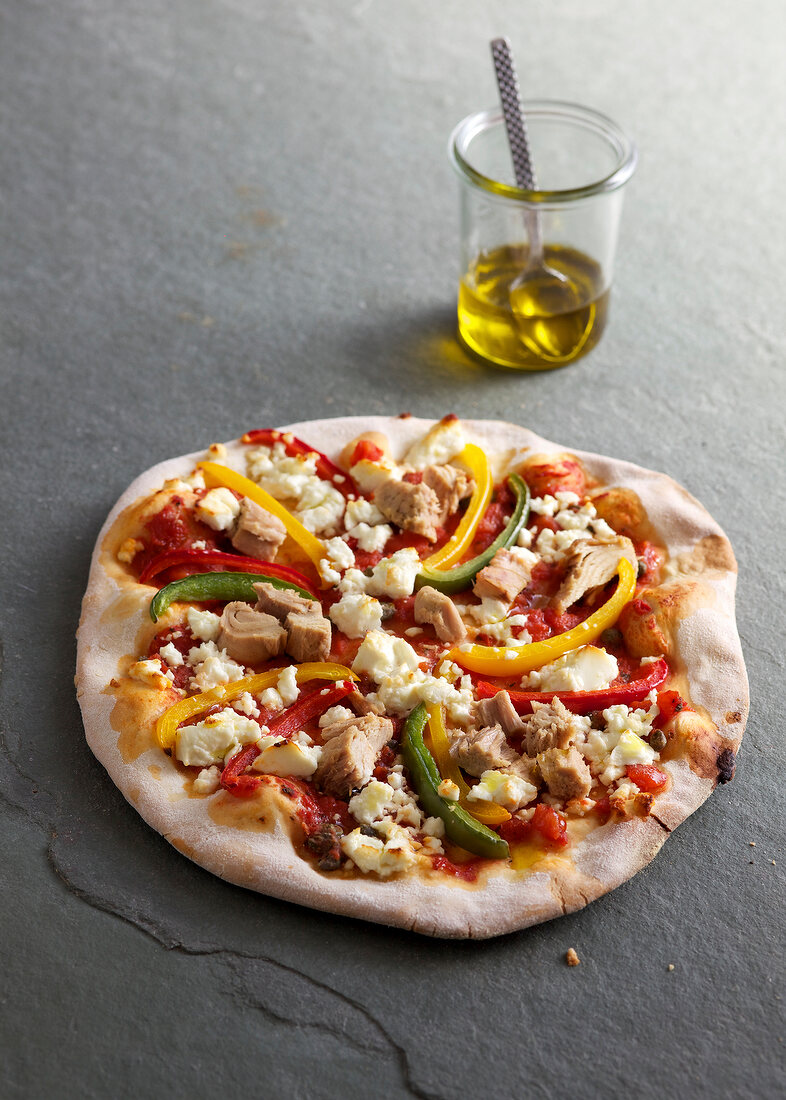 Colourful peppers pizza on gray surface