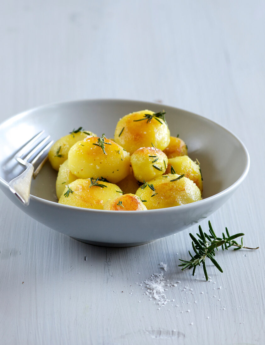 Roasted potatoes with rosemary in bowl