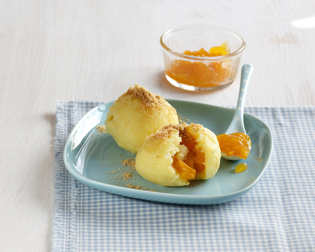 Apricots and marzipan dumplings in serving dish