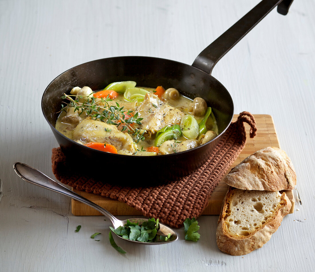 Braised vegetables with chicken in frying pan