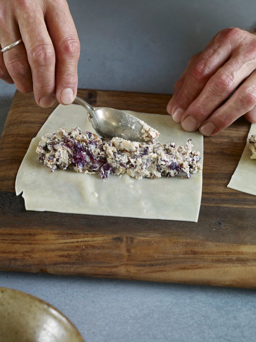 Cannelloni being filled with ricotta and radicchio