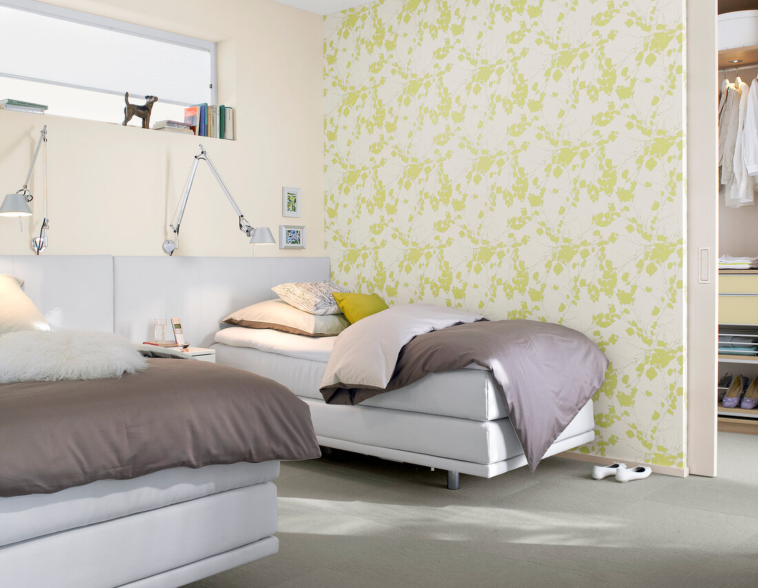 Bedroom with twin bed beside white and green patterned wall