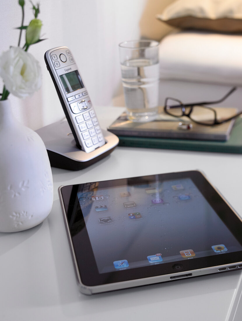 Close-up of iPods and phone on table