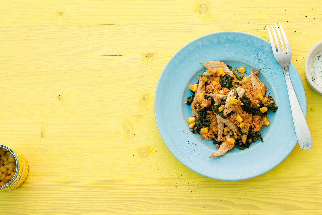 Bulgur and spinach with turkey strips on plate