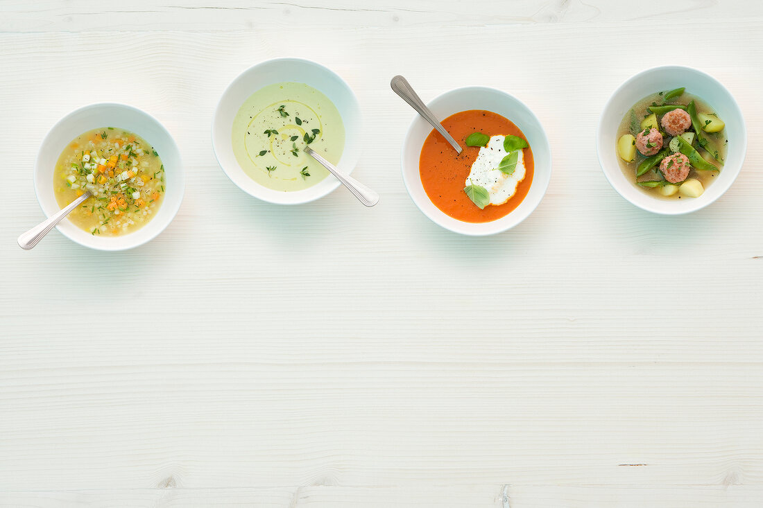 Various soups in bowls, overhead view