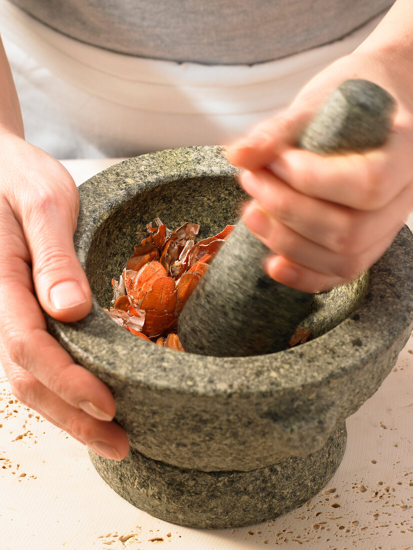 Close-up of lobster carcasses being crushed in mortar