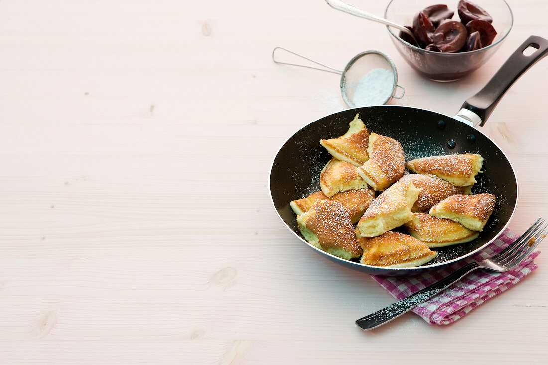 Pancake with plum compote in pan