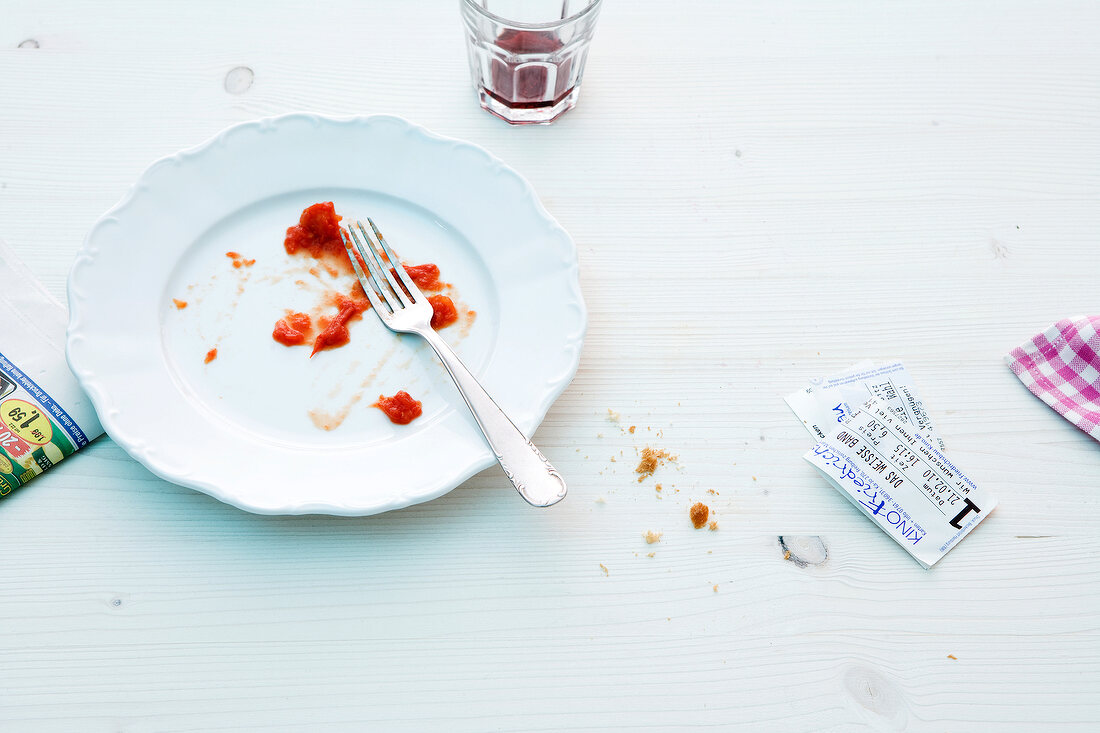 Empty plate with fork and movie tickets on white background