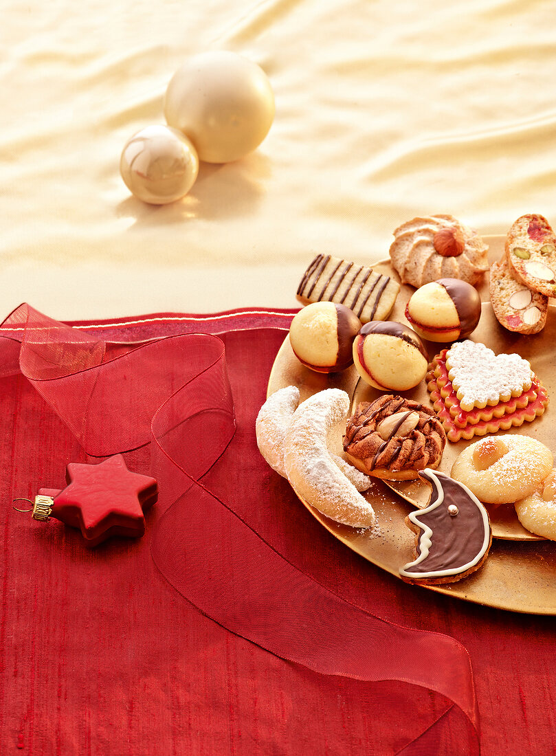 Various shaped cookies on golden plate