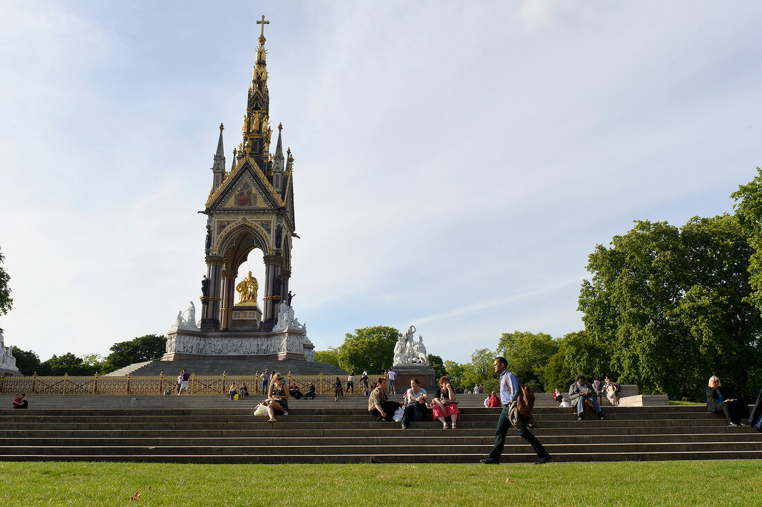 People in Kensington Gardens in Albert Memorial, London, UK